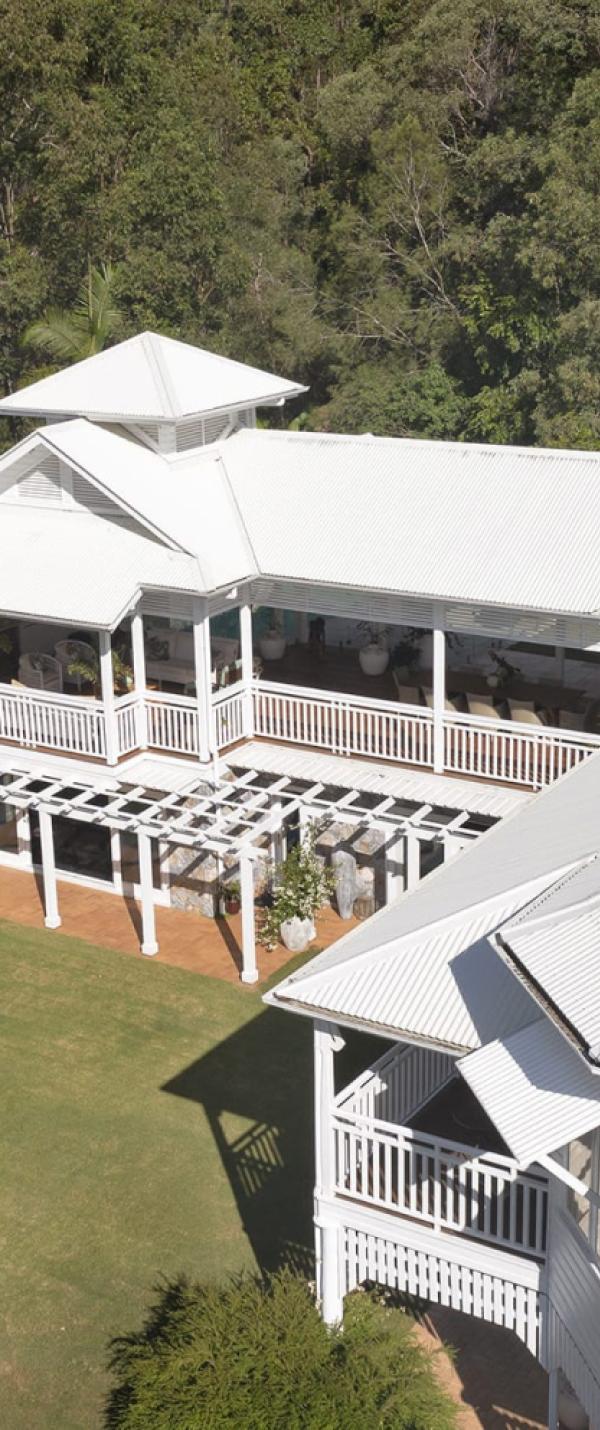 Queenslander house with custom orb roofing in surfmist