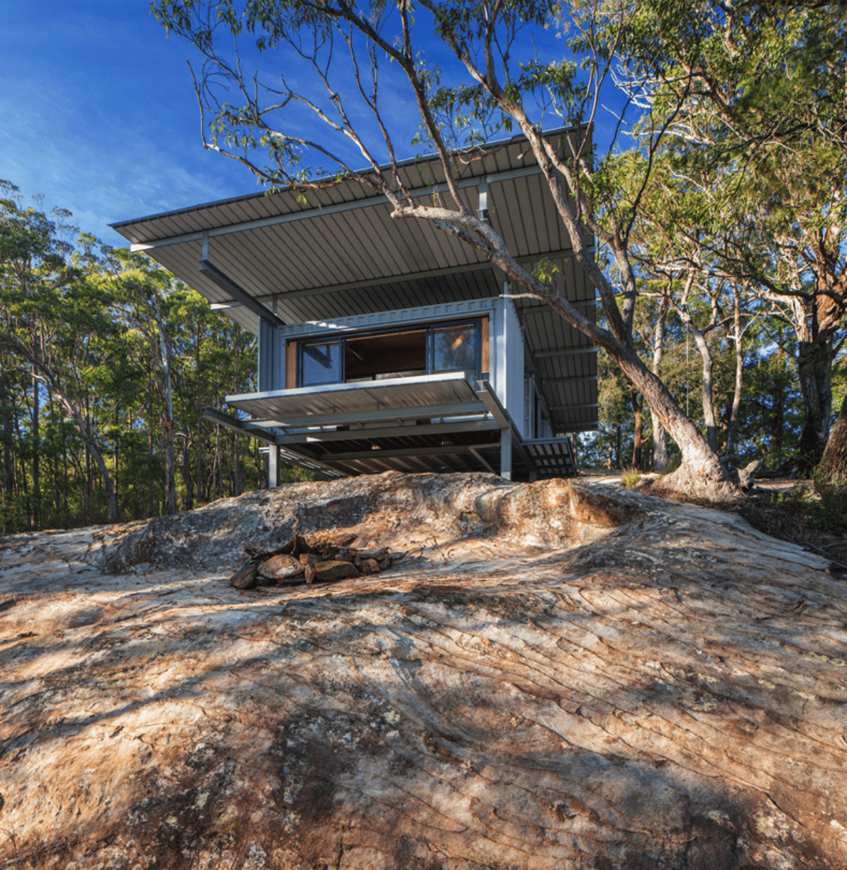 A photo of a home nestled in the bush; a representative example of biophilic design